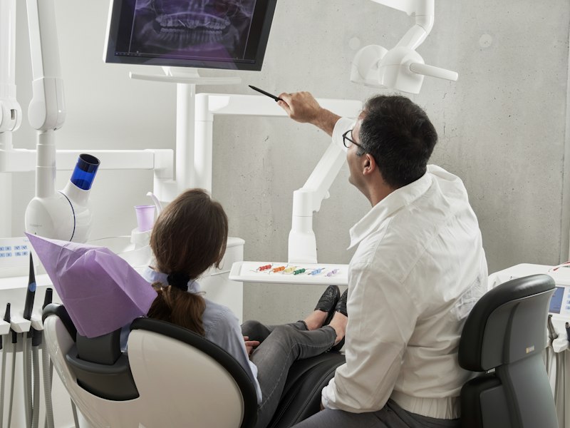 Dentist reviewing an image with a patient