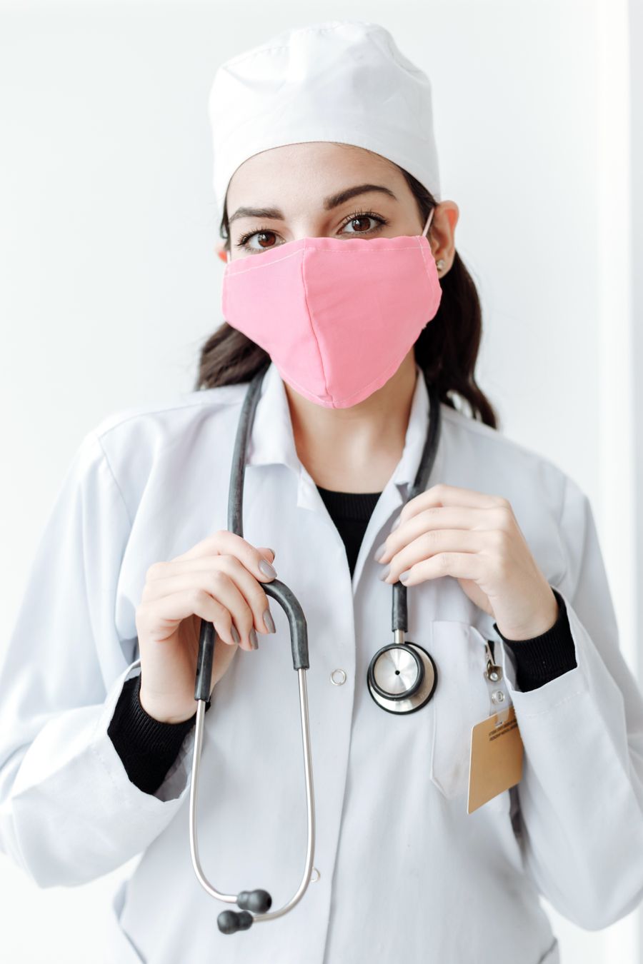 Camille Duret in clinic coat and mask
